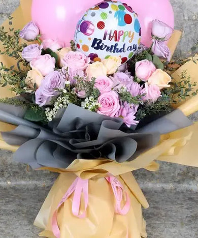 Celebrate a birthday with a bang! Bouquet with roses, balloons, and gift wrap, delivered fresh across UAE.