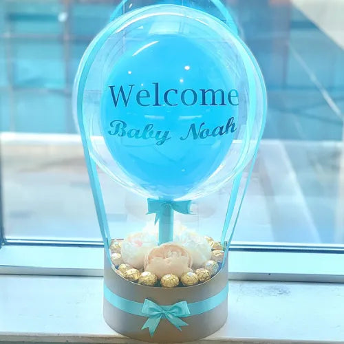 Personalized baby gifts in Dubai, UAE - hot air balloon-inspired Ferrero Rocher and peonies arrangement.