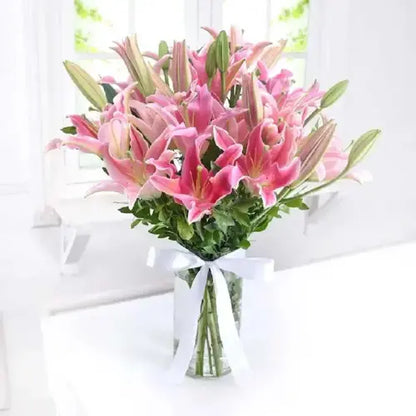 Beautiful pink lilies arrangement with a delicious fudge cake – a perfect gift combo from Giftshop.ae