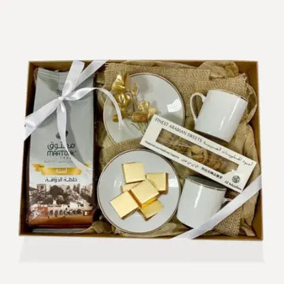 Luxury coffee gift hamper with cups, chocolates, and Arabian sweets in UAE