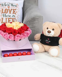 Red, pink, and peach rose bouquet in heart box with chocolates & teddy bear (UAE)