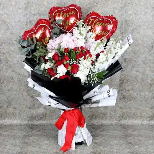 Red and pink flower bouquet with love balloons and gift wrap. Valentine's Day flower delivery Dubai (UAE).