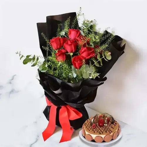 Gift basket with red roses, eucalyptus & triple chocolate cake. Romantic flower & cake delivery UAE.