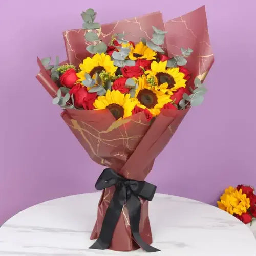 Send romance flower bouquet online in Dubai with sunflowers, red roses, and eucalyptus