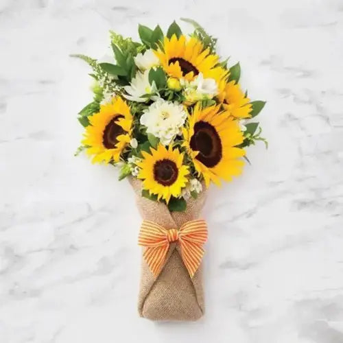 Sunflower and white flower bouquet in natural jute wrapping with ribbon. Dubai flower delivery (UAE)