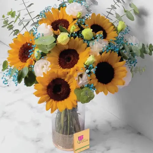 Send a burst of sunshine! Flower arrangement with sunflowers, roses, and baby breath, delivered fresh across UAE.