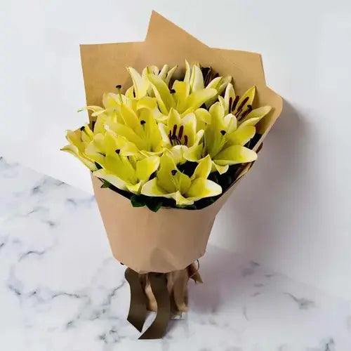 Send a cheerful gift! Yellow lilies & marble cake, delivered fresh across UAE.