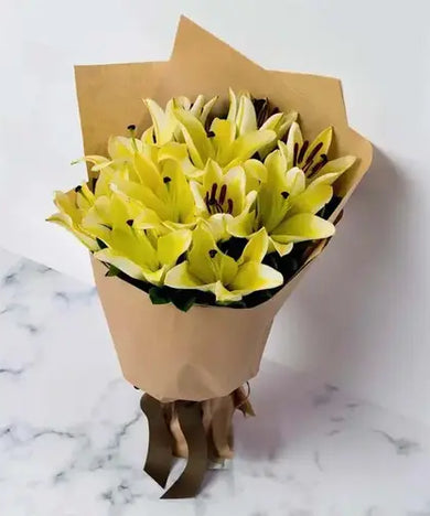 Send a cheerful gift! Yellow lilies & marble cake, delivered fresh across UAE.