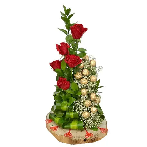 Sweetest love flower arrangement with red roses and chocolates in a wooden vase