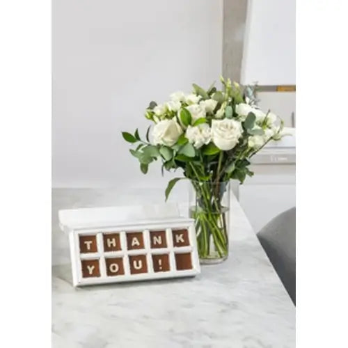 Thank you gift bundle with white roses, alstroemeria, baby roses, eucalyptus, chocolates, and a vase (Show Your Gratitude: Thank You Flowers & Chocolates - giftshop.ae)